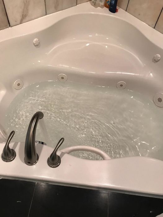 a reviewer's photo of the tub after cleaning, now spotless and ready for use
