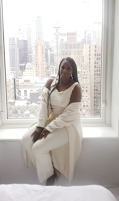 A reviewer modeling the set in white