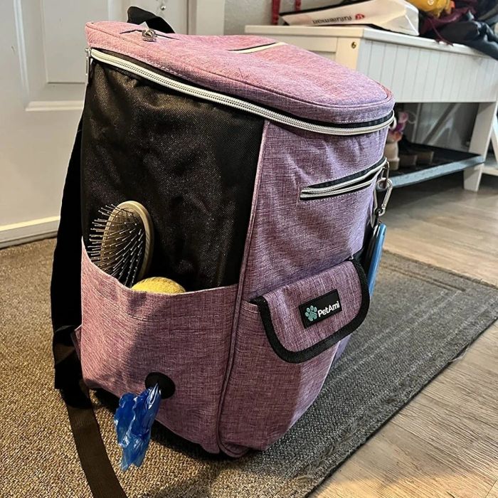 A PetAmi dog travel backpack shown with pockets that hold a brush and poop bags, ideal for shopping trips and travel.