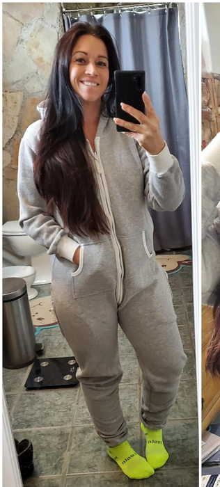 A reviewer snapping a mirror selfie, showcasing the jumpsuit in a sleek gray shade