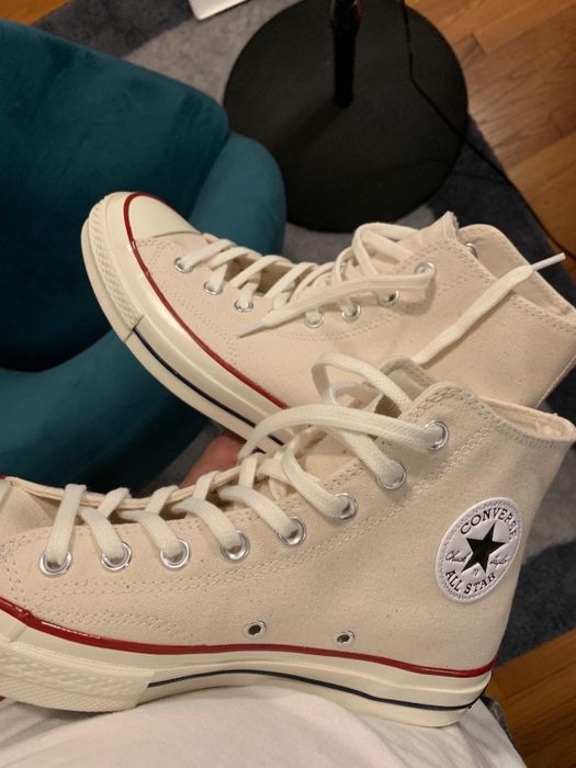 An image of the reviewer wearing off-white Converse shoes