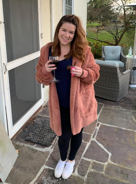 A reviewer showcasing the cardigan in pink