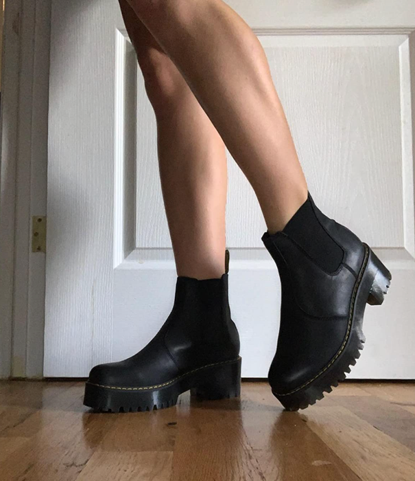 A closeup of a reviewer wearing slip-on boots.