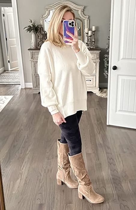 Reviewer showcasing the sweater in a pristine white color