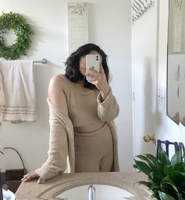 A reviewer showcasing the set in camel