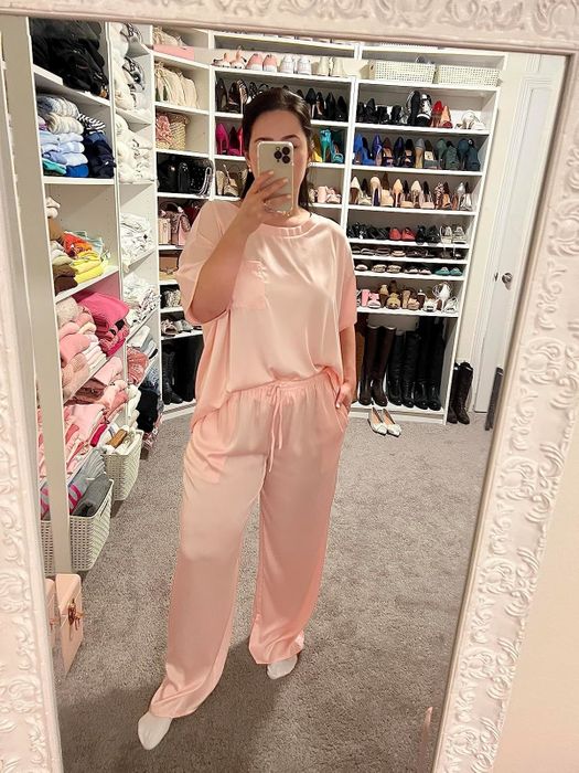 A reviewer capturing a mirror selfie while wearing silk pajamas
