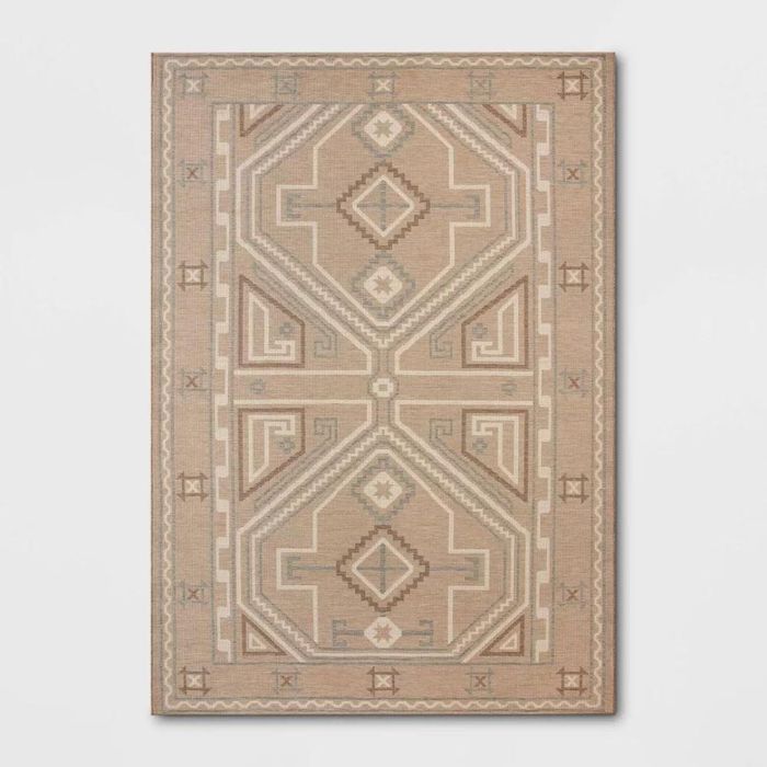 A beige, cream, and brown rug with a modern Persian-inspired design