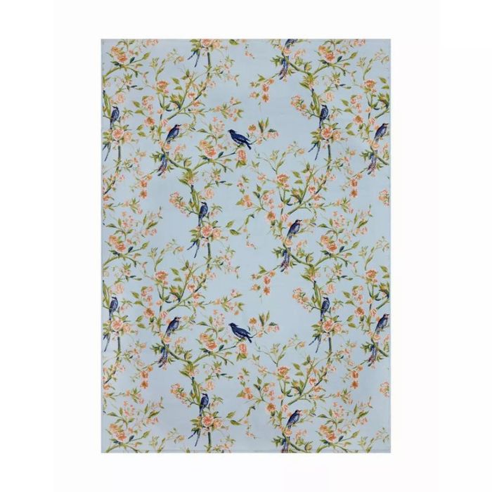 A blue rug featuring a floral pattern with birds