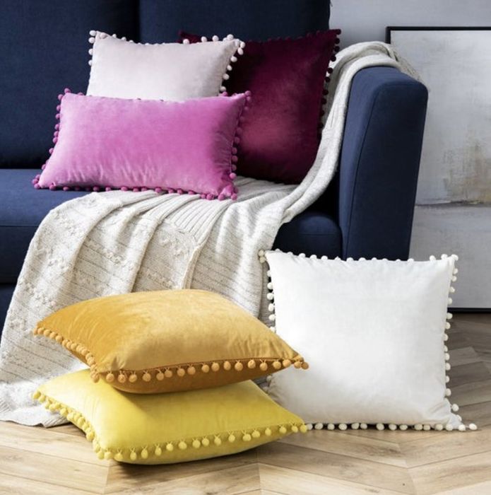The vibrant pillows scattered across the couch and floor.