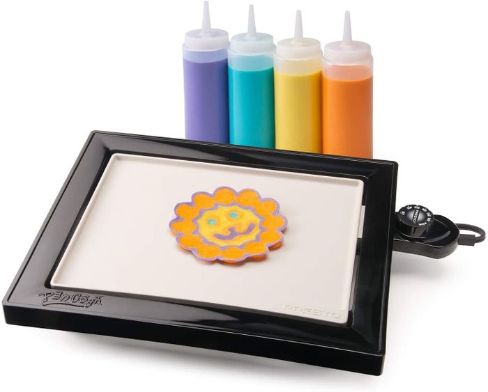 a griddle accompanied by four squeeze bottles filled with vibrant pancake batter