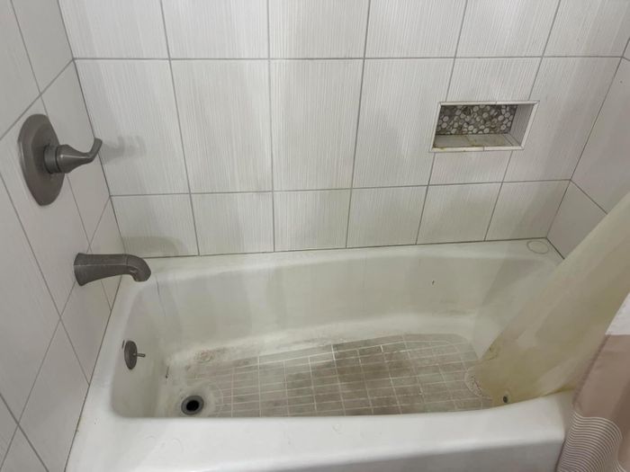 photo of a bathtub before using the cleaner