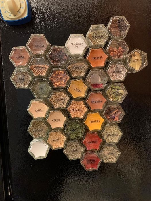A different reviewer's setup with large spice jars neatly arranged on the side of the fridge