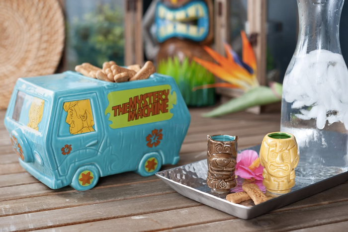 a punch bowl shaped like the iconic van, paired with small tiki mugs featuring Scooby and Shaggy designs