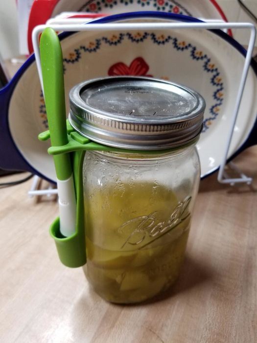 a mason jar equipped with a holster and a small fork inside