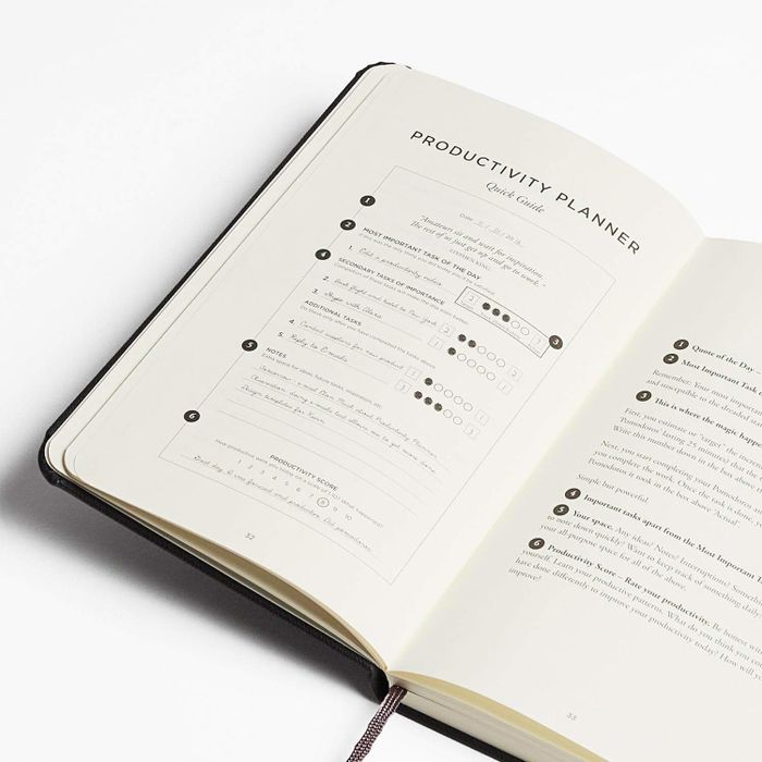 a productivity planner shown open, displaying one of its pages