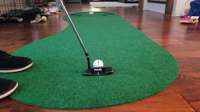 a putting green set up in a cozy living room