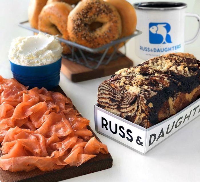 a selection of smoked salmon, bagels, cream cheese, coffee, and chocolate babka