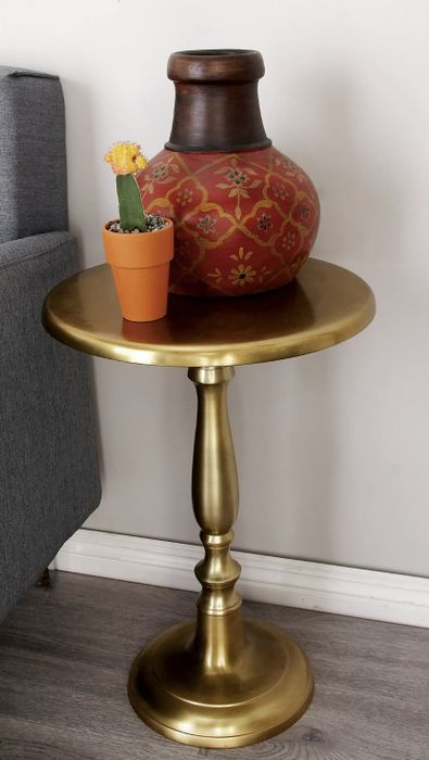 The metal side table adorned with two potted plants.