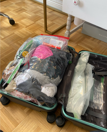 The clothes neatly packed into compression bags, now fitting perfectly into the suitcase