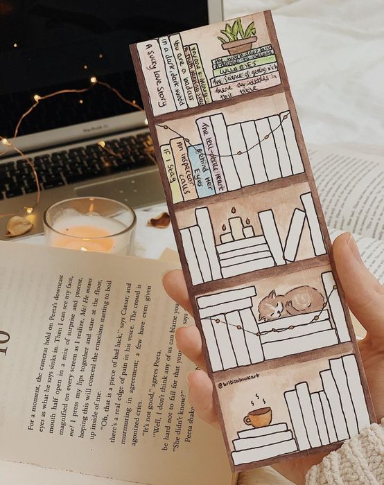 a person holding the bookmark in their hand