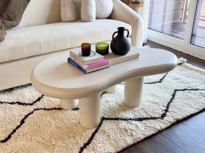 A modern coffee table adorned with decor and books, set in a cozy living room environment. Perfect for interior design inspiration.