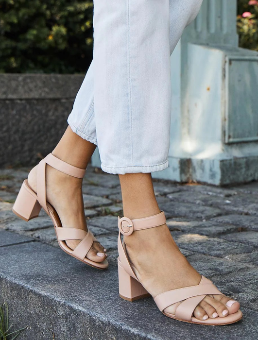model's feet in beige sandals