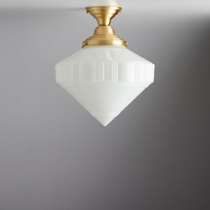 A diamond-shaped flush mount light fixture attached to the ceiling, featuring a decorative gold base for a touch of elegance.