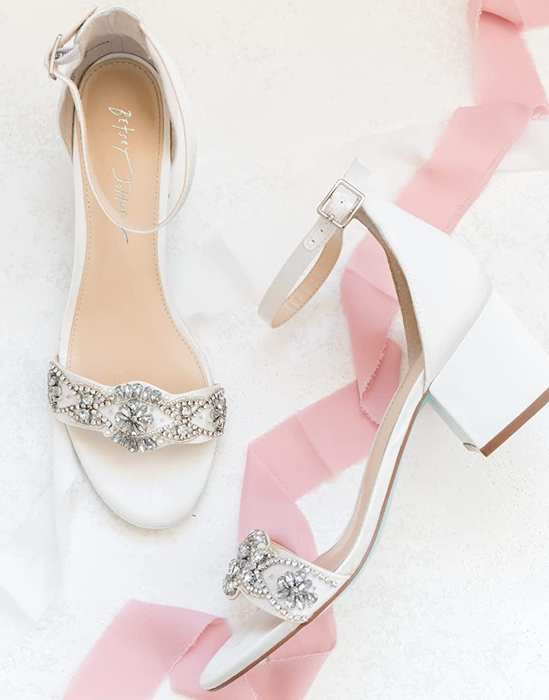 white ankle strap sandals with crystal detailing on the toe strap