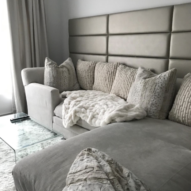 Living room walls adorned with panels in a color that complements the sofa perfectly.