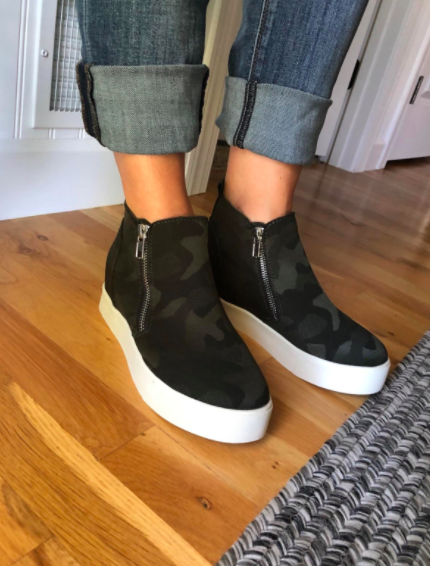 The reviewer pairs camo-print platform sneakers with cuffed denim for a trendy and casual look.