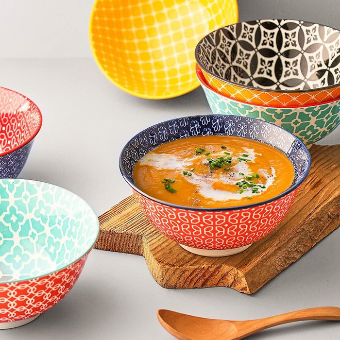 A collection of bowls with clashing patterns, making for a lively and eclectic dining set.