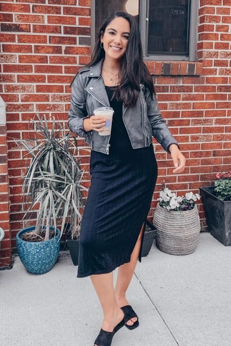 Two photos of a reviewer showcasing the black leather jacket.