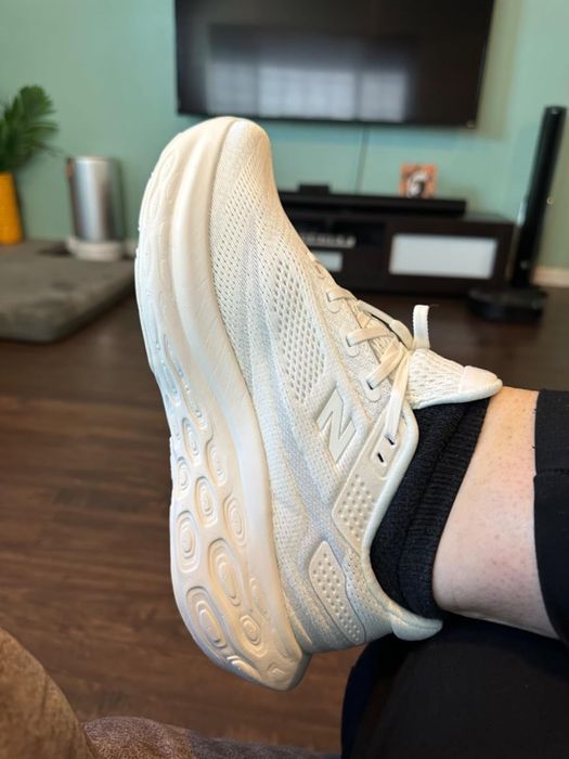 Person showcasing New Balance sneakers, emphasizing the shoe's unique design