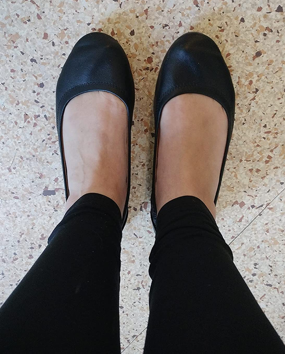 reviewer wearing black flats