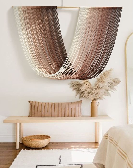 A length of yarn elegantly draped from a horizontal stick.