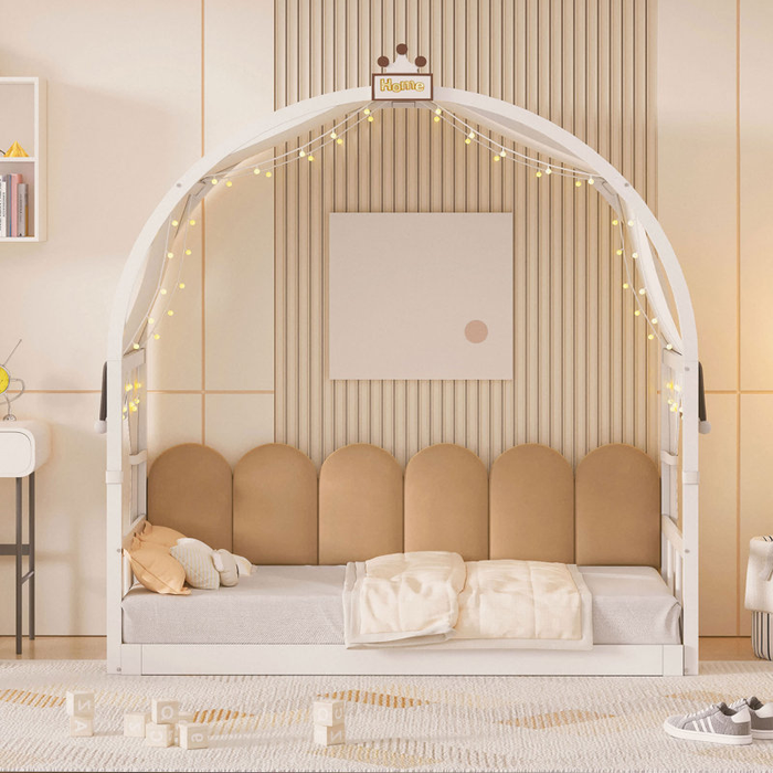 This stylish children's bed comes with an arch canopy, plush pillows, and decorative lights, all set in a modern playroom filled with toys and fun decor.