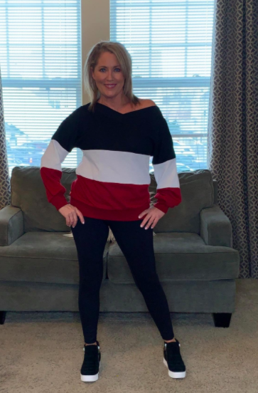 The reviewer sports the same pair of platform sneakers with a striped sweater and black leggings for a simple yet stylish outfit.