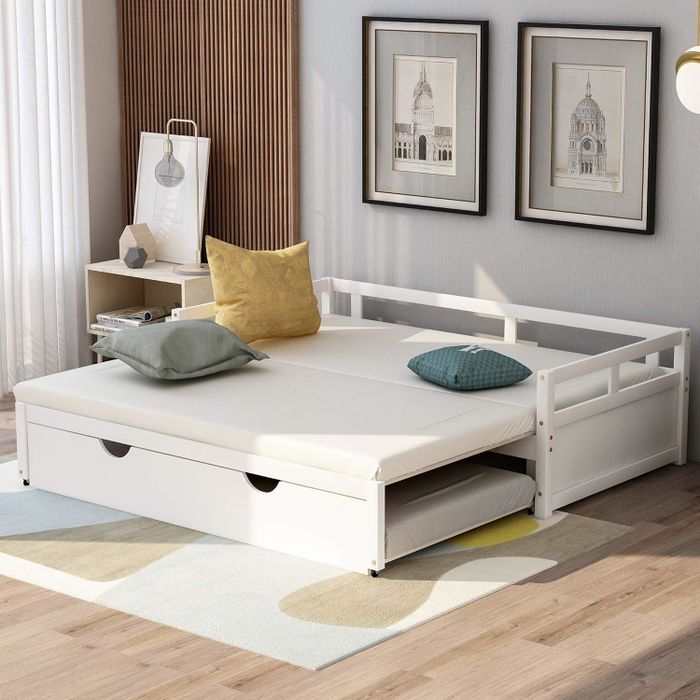 A modern white daybed, extended to provide additional space.