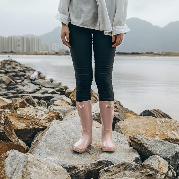 Person sporting light pink rain boots