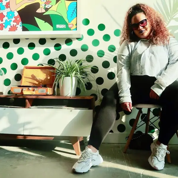 editor styling the Adidas sneakers with leggings and a cropped sweatshirt