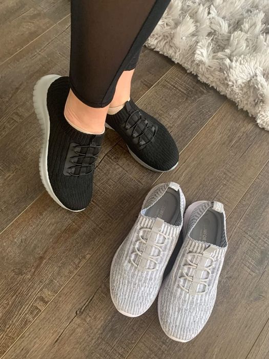 Another reviewer showcasing the black sneakers and displaying their second pair in gray.