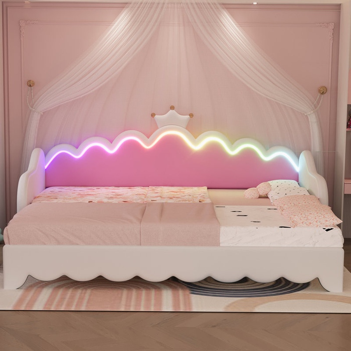 This children's bed, complete with a scalloped headboard, rainbow LED lights, and a canopy, is paired with playful bedding, making it a perfect addition to a stylish kid's room.