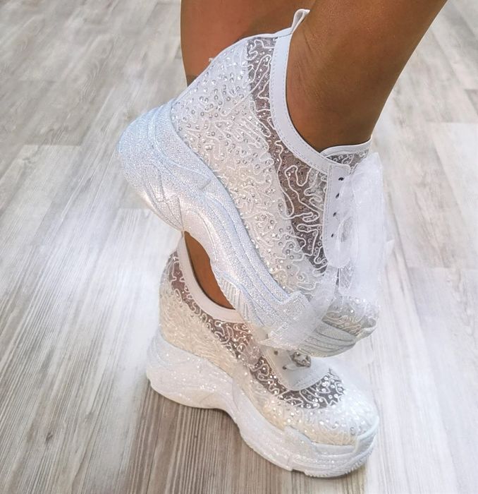 model wearing white wedding sneakers