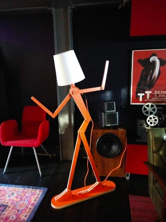 A vibrant lamp designed to resemble a thin, spindly figure.