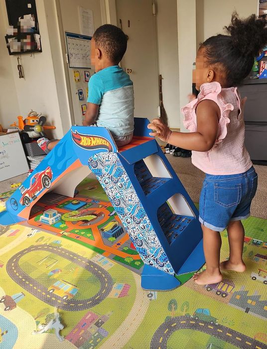 Hot Wheels slide with two children playing on it
