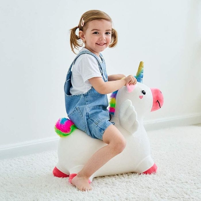 A child riding the inflatable unicorn toy