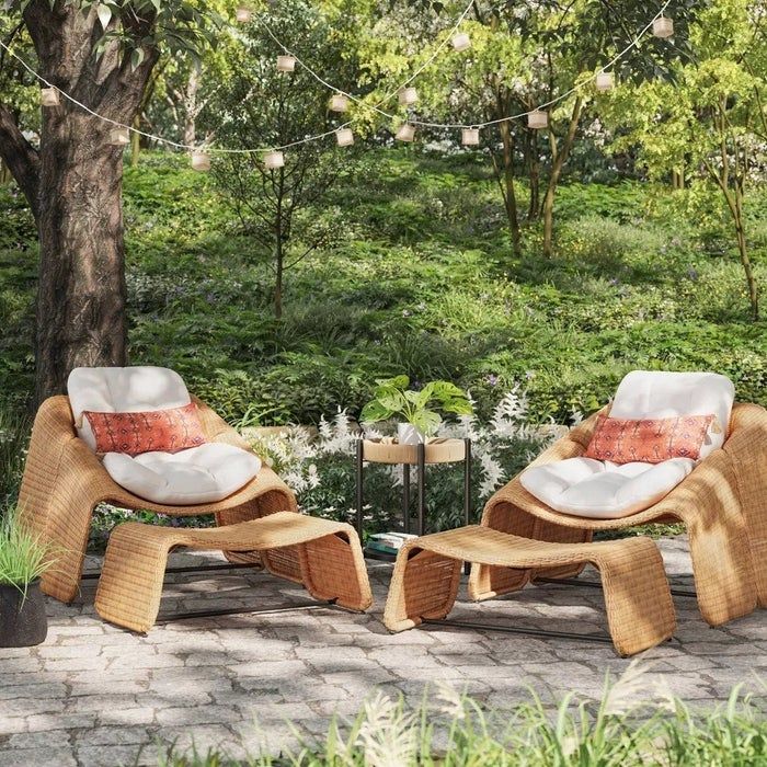Two chairs and ottomans placed on a patio