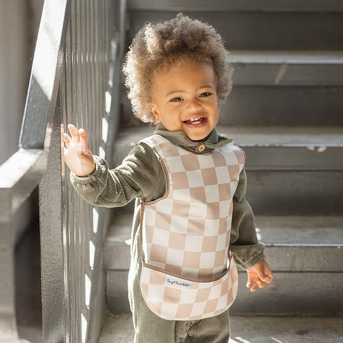 A child wearing the checkered apron bib
