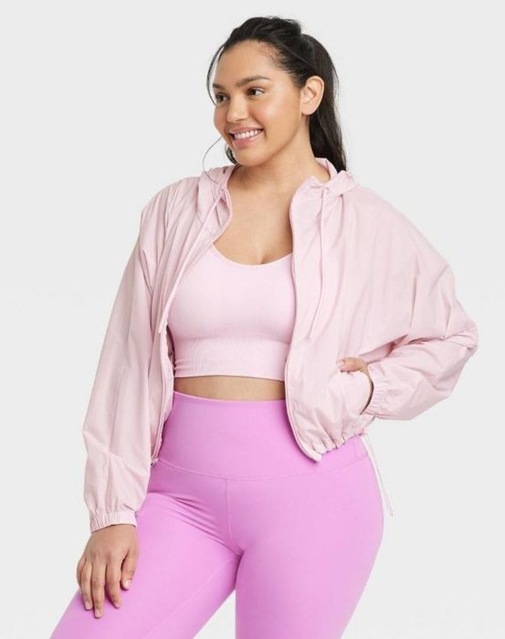 Model wearing a pink rain jacket.