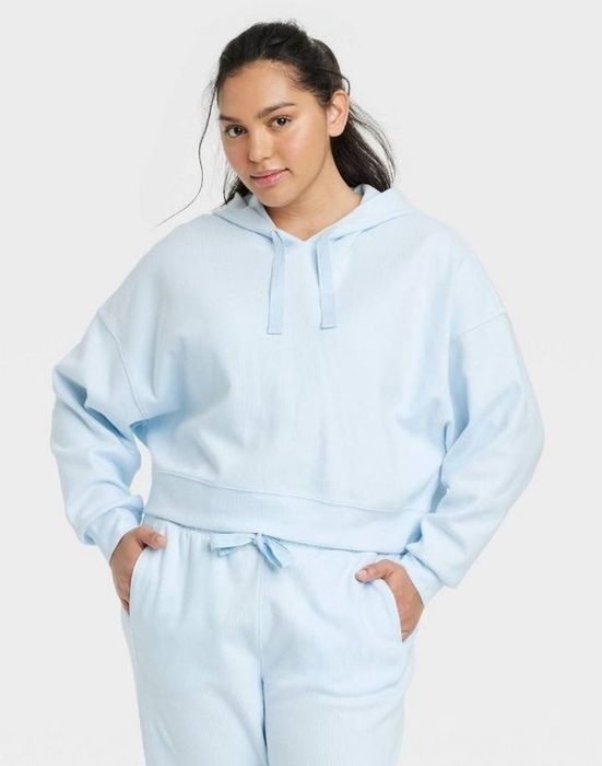 Model wearing a light blue ribbed hoodie.